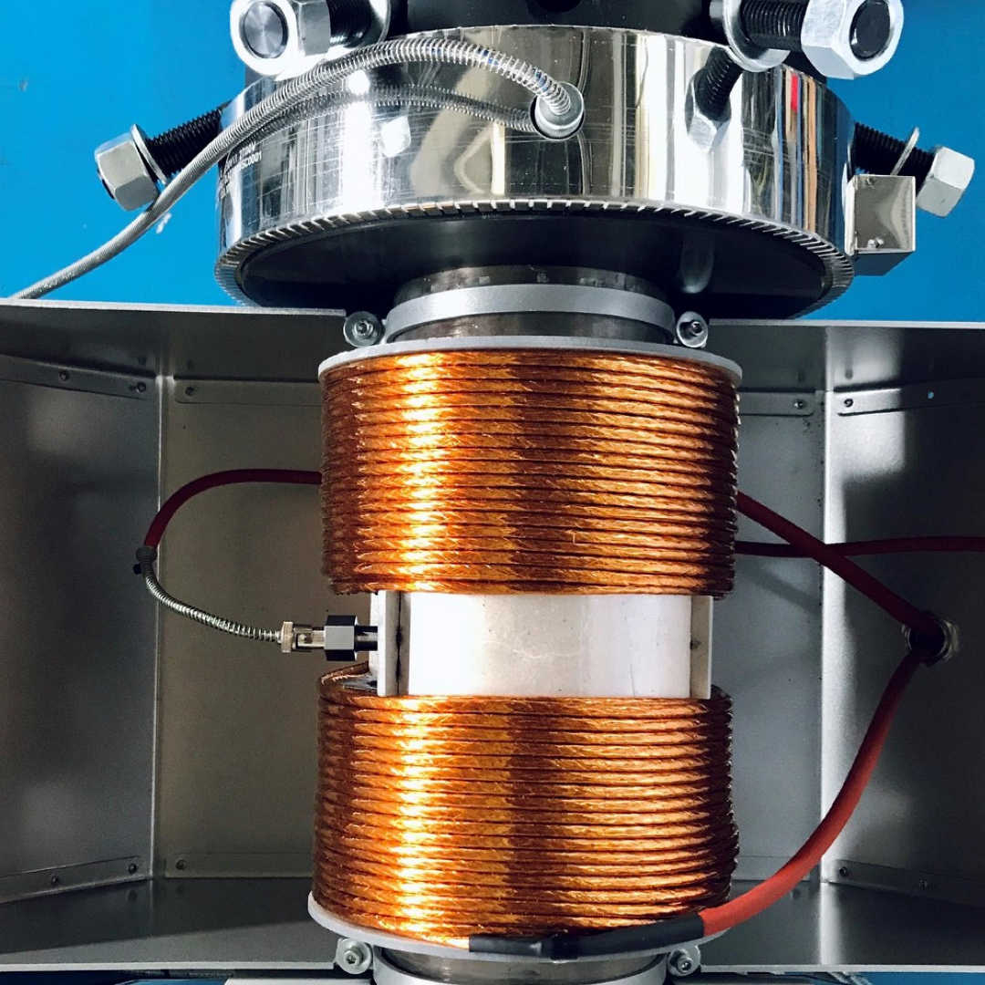 Overhead photo shows the induction coils of the Smart Energy System wrapped around an extruder barrel.