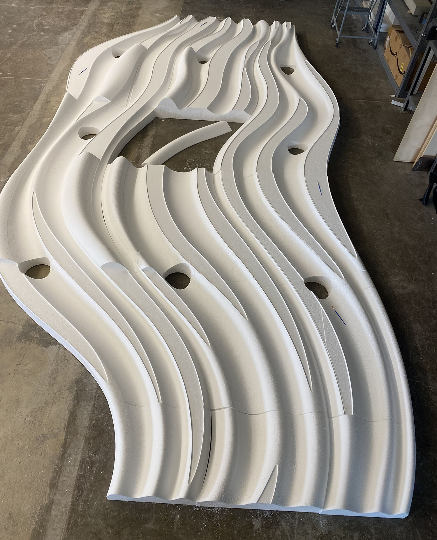 The team acquired 32 slabs of white EPS foam as the raw material for the project. They then glued some together and shaped them. The ceiling design involved milling intricate shapes. 