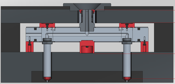 A hot runner system consists of a heated manifold and nozzles in plastics injection molds that keep the thermoplastic material in a molten state throughout the molding process. This system is thermally isolated from the rest of the mold, ensuring that the plastic stays liquid until it reaches the mold cavities. Courtesy of Witosa 