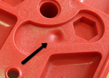 Sink marks deform the surface of a part in areas with thick geometry. Uneven cooling of the material causes these deformations. Courtesy of Hawk Ridge Systems.