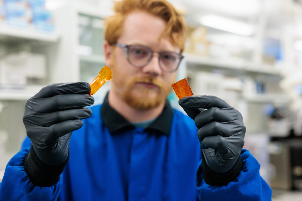 Graduate student Nicholas Boynton demonstrates how a new pluripotent plastic can take on different characteristics. Courtesy of University of Chicago Pritzker Molecular Engineering/John Zich.